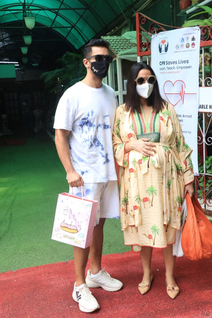 Neha Dhupia, who welcomed a baby boy with husband Angad Bedi on Sunday, was pictured in Bandra with him yesterday.