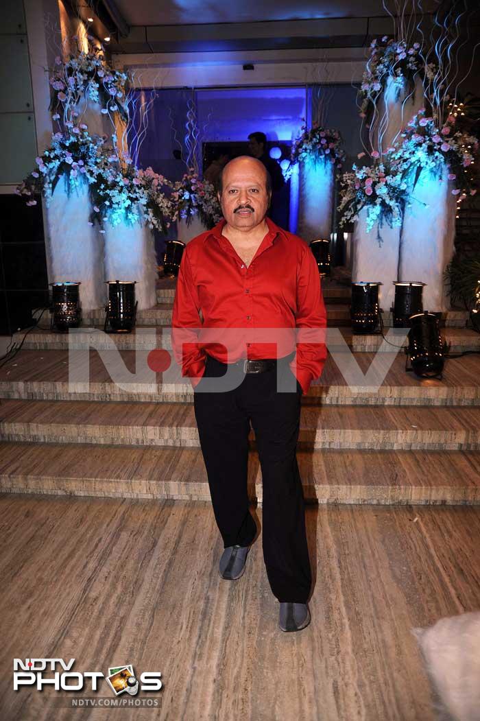 Rajesh Roshan shines in a bright red shirt.