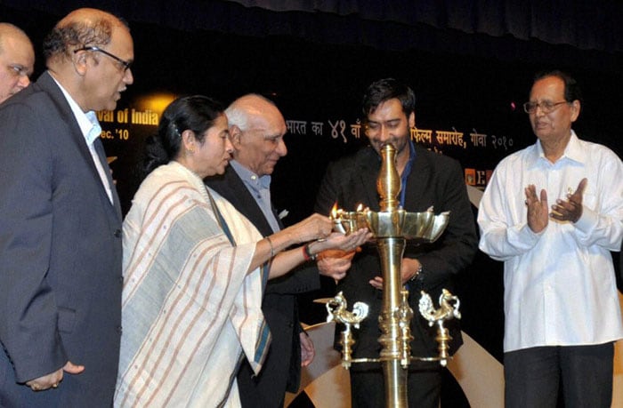Goa Chief Minister Digambar Kamat looks on as Union Railways Minister Mamata Banerjee filmmaker Yash Chopra and actor Ajay Devgn light the lamps during the inauguration of the 41st International Film Festival (IFFI-2010). (Photo: PTI)