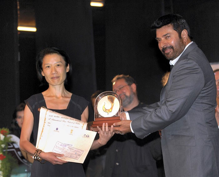 Actor Mammootty presents the Silver Peacock award to Korean director Ounie Lecomte for her film ?A brand new life' during the closing ceremony of the 40th International Film Festival of India at Kala Academy, in Panaji on Thursday. (Photo: PTI)
