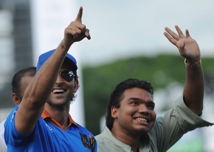 Hrithik Roshan accompanied by Namal Rajapakse, son of Sri Lankan president Mahinda Rajapakse, greets fans during a cricket match between Indian Bollywood actors and Sri Lankan cricketers during the three day International Indian Film Academy (IIFA) awards events in Colombo on June 4, 2010.