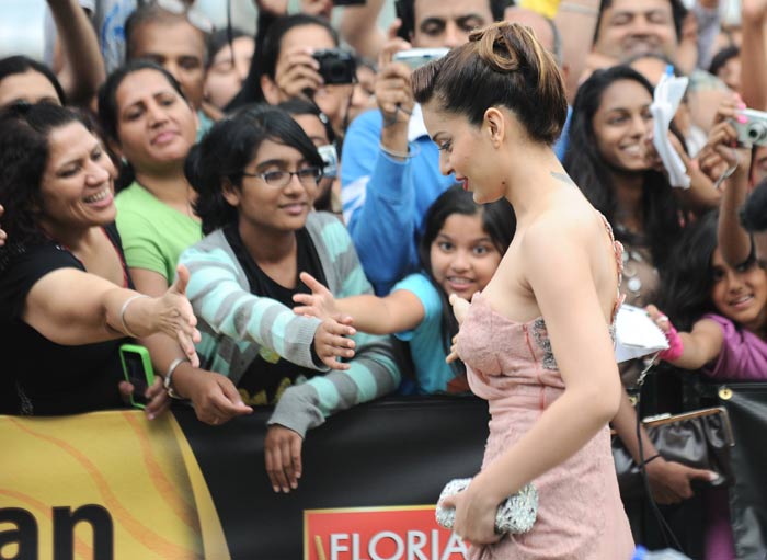 Kangana Ranaut is happy meeting fans on the green carpet.