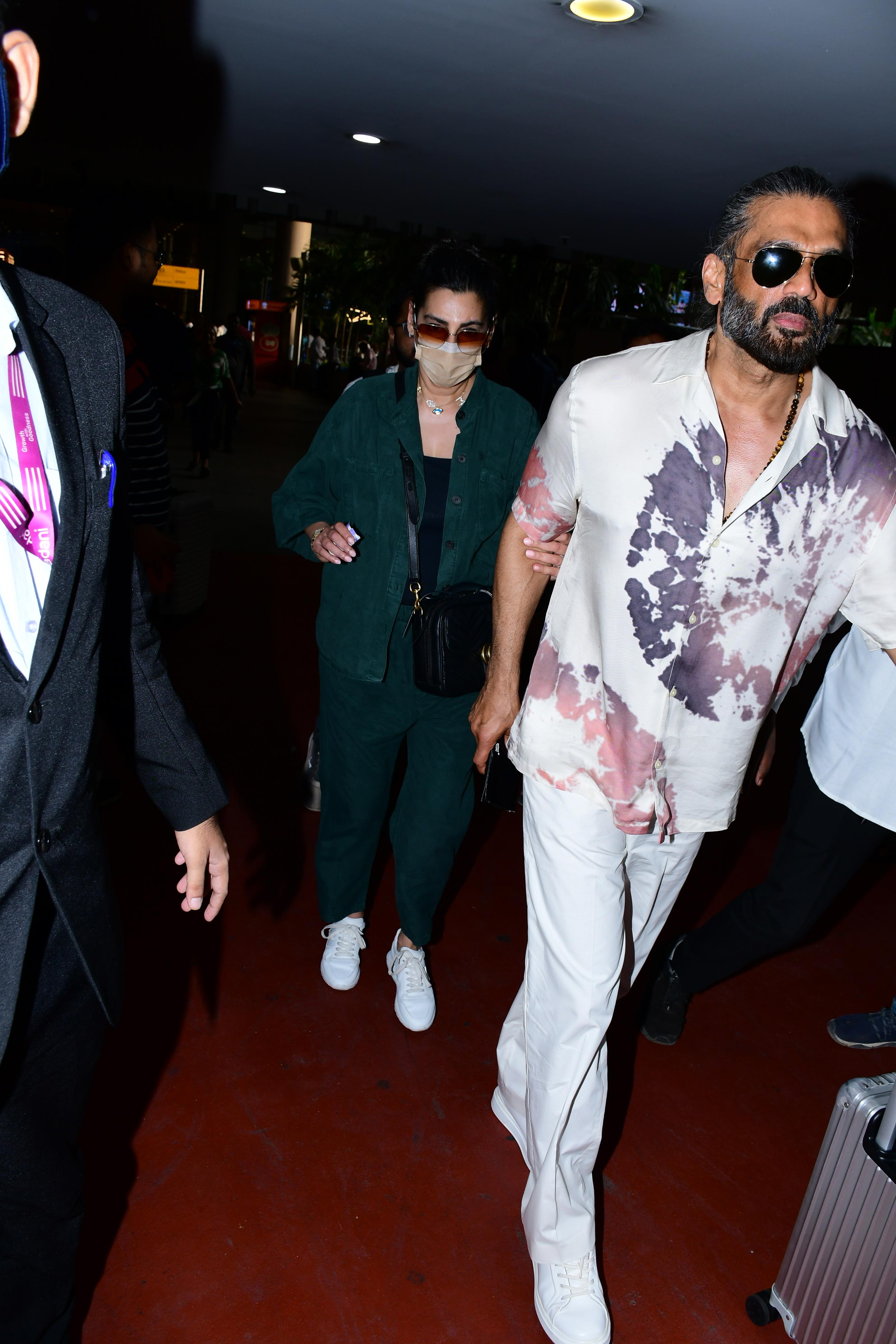 Suniel Shetty was snapped with his wife Mana Shetty at the airport.