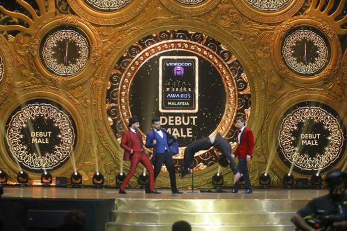 While hosts Ranveer Singh and Arjun Kapoor applauded <i>Heropanti</i> actor Tiger Shroff's back flip, a much impressed Hrithik in red tuxedo stood by to watch. <br><br>This image was posted on Twitter by <a href="https://twitter.com/IIFA" target="_blank" rel="nofollow" >IIFA Awards </a>