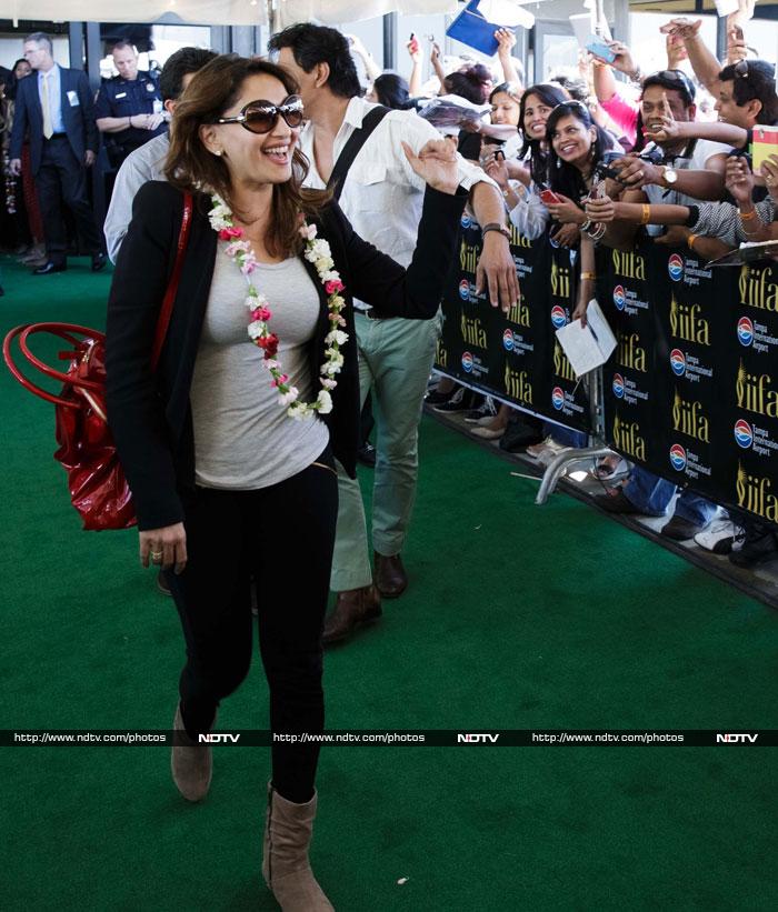 A garlanded Madhuri Dixit also smiled and waved.