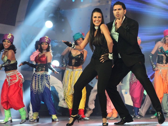 Yuvraj Singh (R) performs on stage with actress Neha Dhupia (L) at the IPL Awards Night at the Grand Hyatt on April 23, 2010 in Mumbai, India. (Photo: Getty Images)