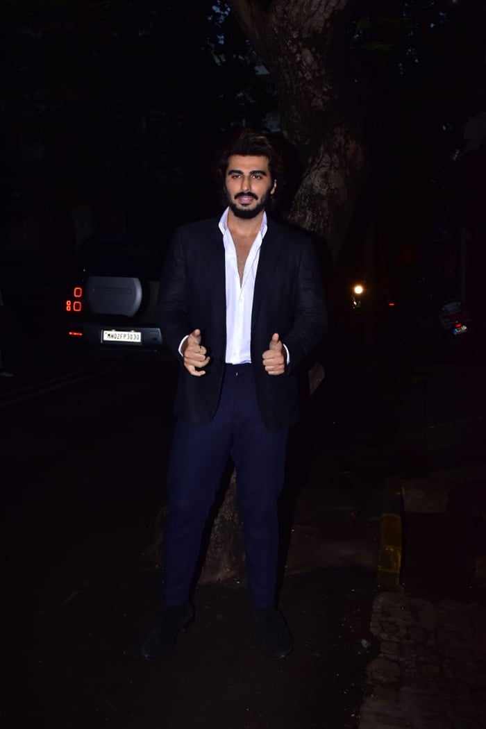 Arjun Kapoor wore a white shirt and blue suit for his cousin's wedding reception.