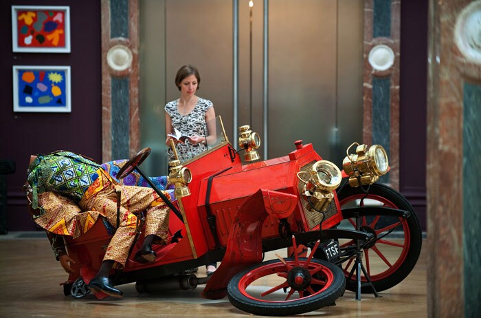 A woman looks at 'Crash Willy' by Yinka Shonibare, during a photocall for the Royal College of Art's Summer Exhibition, in central London on June 9, 2010. The exhibition is set to run from June 14 until August 22. (Photo: AFP)