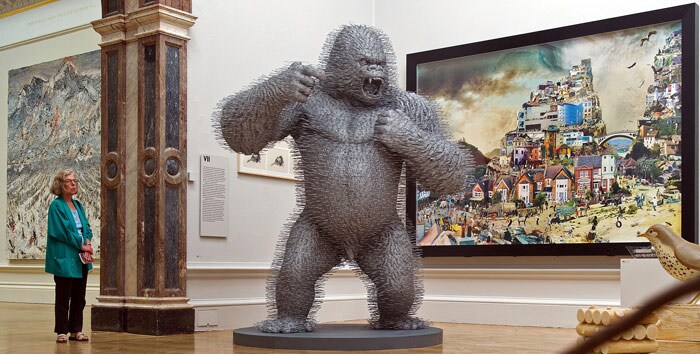 A woman looks at 'Silver Streak', by David Mach, constructued entirely by coathangers, during a photocall for the Royal College of Art's Summer Exhibition, in central London on June 9, 2010. The exhibition is set to run from June 14 until August 22. (Photo: AFP)