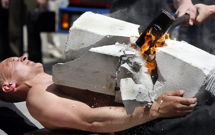 A member of the special troops of the Belarus Interior Ministry demonstrates his bravery and skills during a military show in Minsk, Belarus, on Wednesday, June 9, 2010. (Photo: AP)