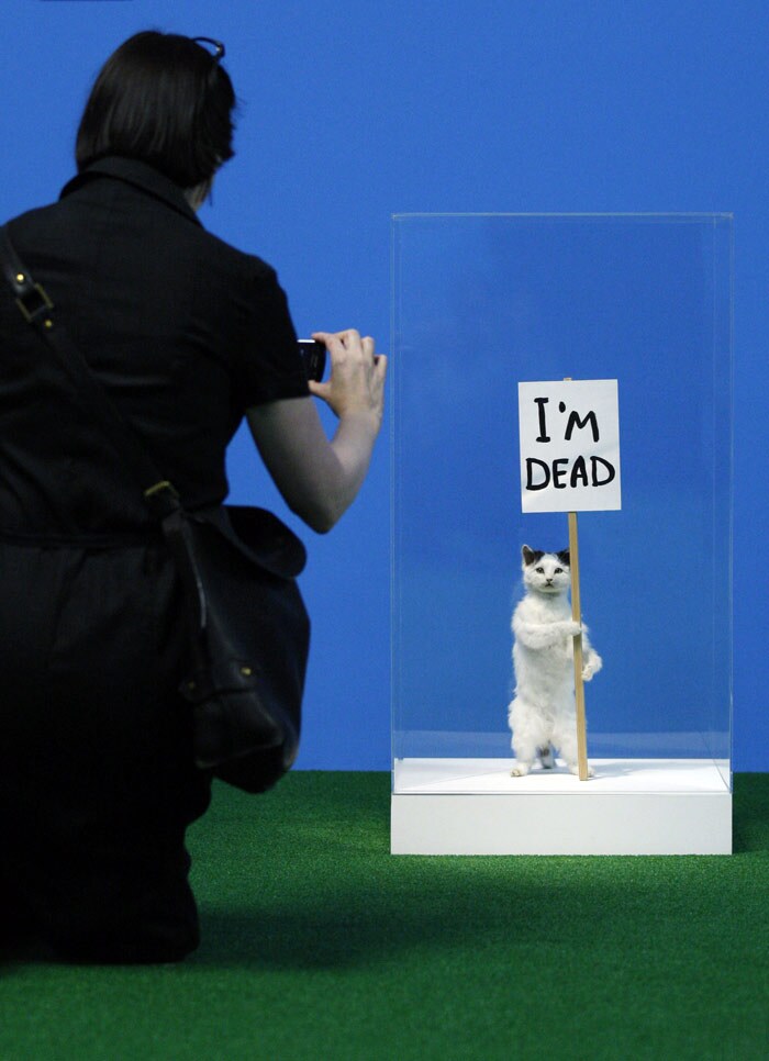 A visitor photographs a sculpture 'I'm Dead' by David Shrigley on display in an exhibition 'Rude Britannia: British Comic Art' at Tate Britain in London, on Monday, June 7, 2010. The exhibition explores British comic art from the 1600's to the present day and celebrates a rich history of cartooning and visual jokes.(Photo: AP)