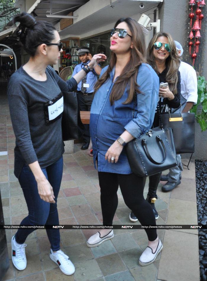 Karisma stayed by Kareena's side as the paparazzi closed in for some pictures.