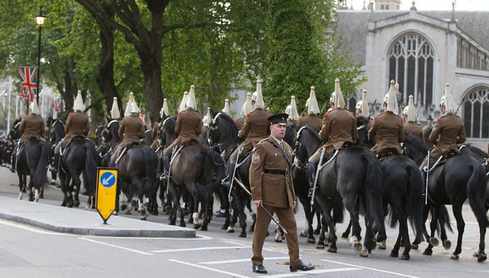 Soldiers of the Household Cavalry  under the gaze of a senior NCO. (Photo: AP)