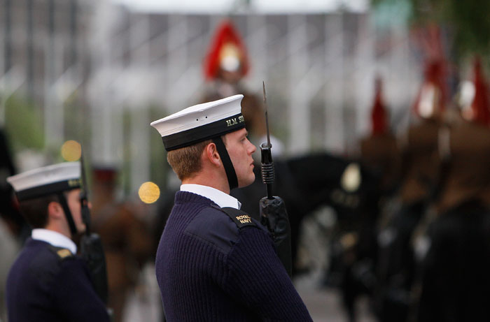 A sailor from the British Royal Navy stands easy as he takes part in an overnight dress rehearsal for the Royal Wedding. (Photo: AP)