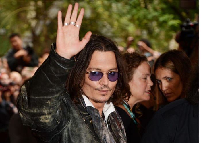 Johnny Depp waves to the crowds at the premiere of the documentary West of Memphis at the Toronto Film Festival. He is all covered up in his leather jacket and makes his presence felt even sans the glamorous look.