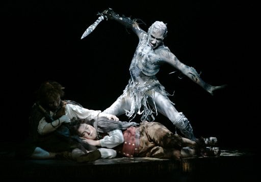 James Loye as Frodo, centre, Peter Howe as Sam, right, and David Grant as a Black Rider perform in a scene set in The Old Forest from the theatre show Lord of the Rings.