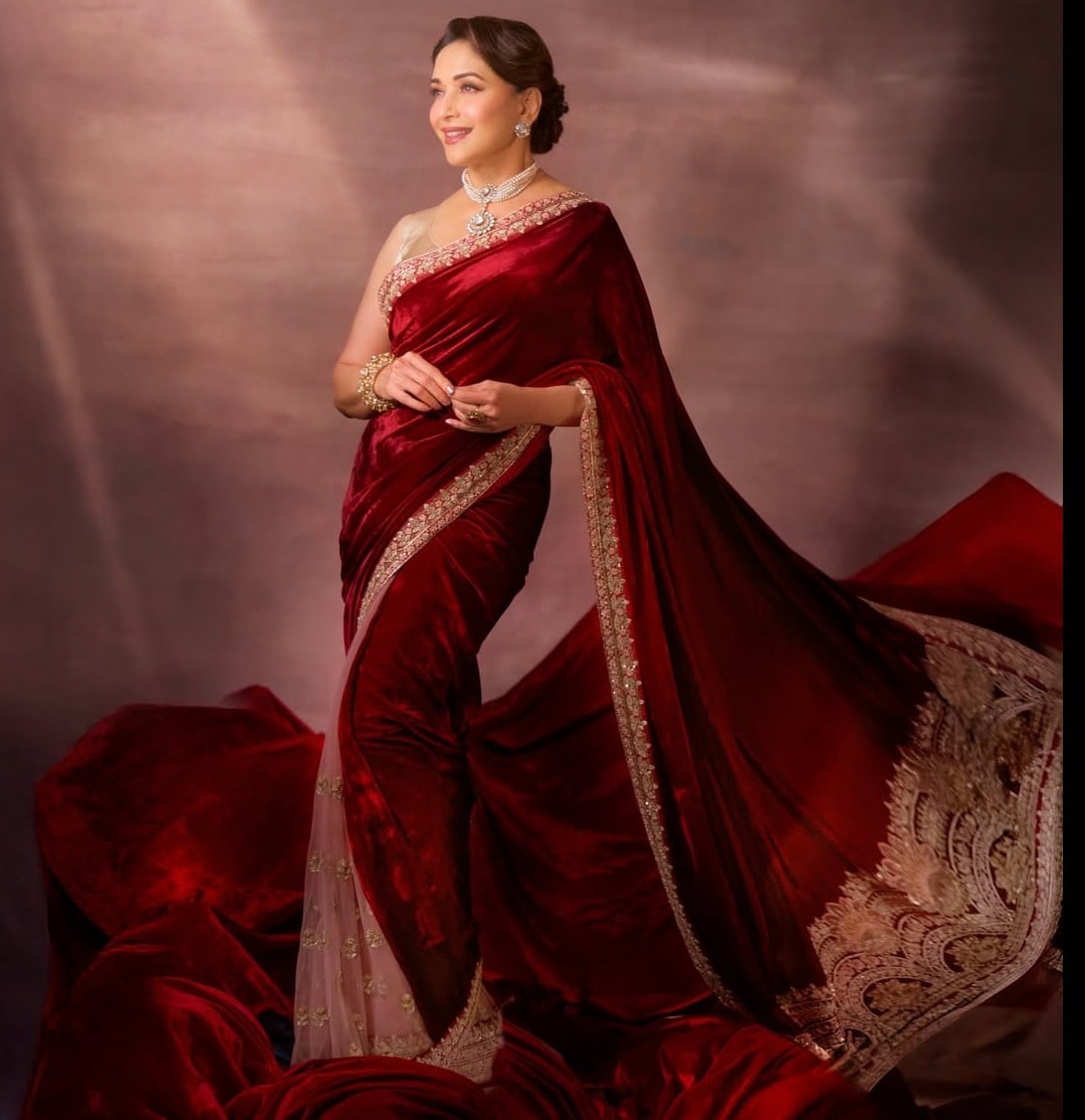 वेलवेट रेड साड़ी और गोल्डन बॉर्डर क्लासिक अपीयरेंस दे सकते हैं. madhuridixitnene/Instagram