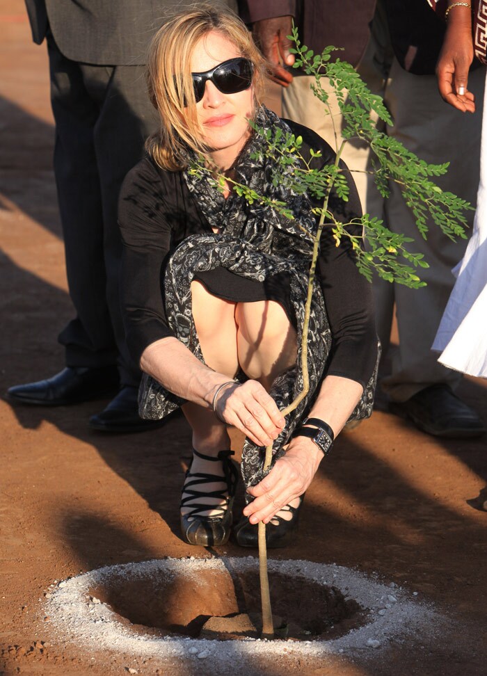 US pop star Madonna plants a tree at a ground breaking ceremony for her Raising Malawi Academy for Girls in Malawi. Madonna who is funding the building of the school was the guest of honour at the function. The 51-year-old celebrity arrived in the impoverished southern African country on Sunday. She was accompanied by her four children _ daughters Lourdes and Mercy, and sons Rocco and David. (Photo: AP)