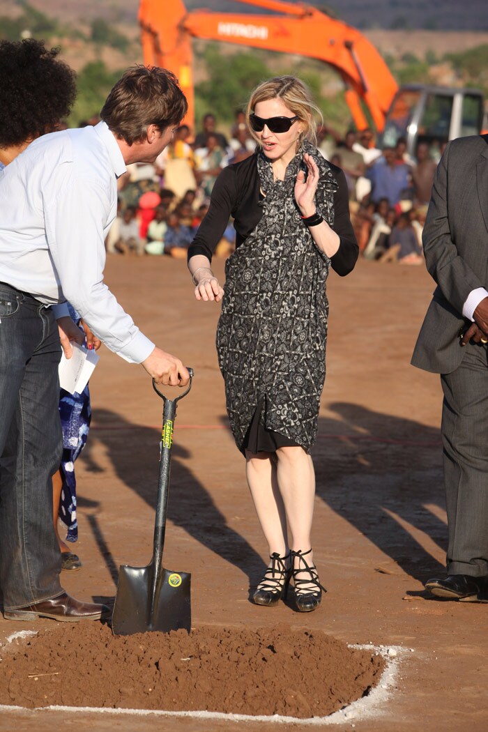 US pop star Madonna plants a tree at a ground breaking ceremony for the Raising Malawi Academy for Girls in Malawi, Monday, Oct., 26, 2009. Madonna, who is funding the building of the school was the guest of honour at the function. (Photo: AP)