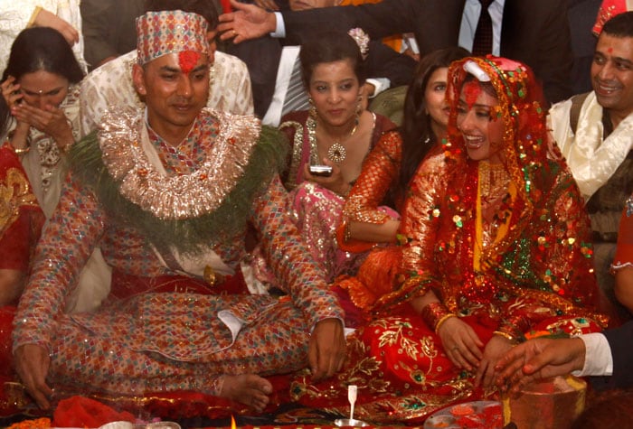 Manisha Koirala, right, and groom Samrat Dahal perform rituals at a resort just outside Katmandu, Nepal.