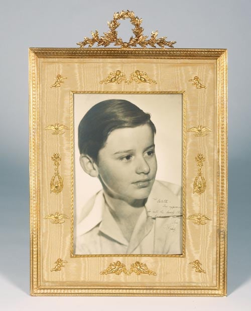 A vintage sepia photograph of Roddy Mcdowall in an elaborately decorated frame, inscribed in black ink, <I>To Estelle In appreciation for all the lovely things you have done for me Love Roddy</i>.