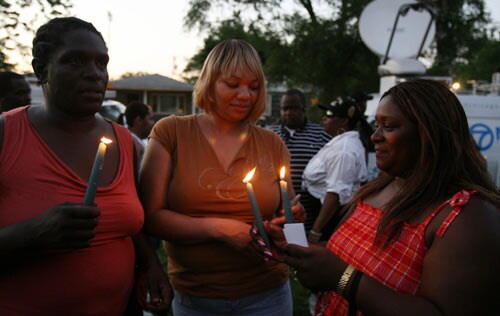People gather and hold candles for a vigil outside the former childhood home of Pop Star Michael Jackson.