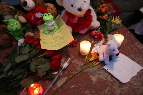 Candles, notes and stuffed animals are displayed as people gather outside the former childhood home of Pop Star Michael Jackson.