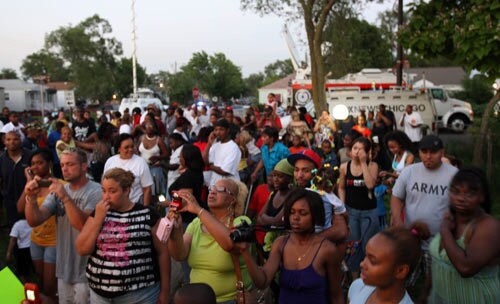 People gather outside the former childhood home of Pop Star Michael Jackson.