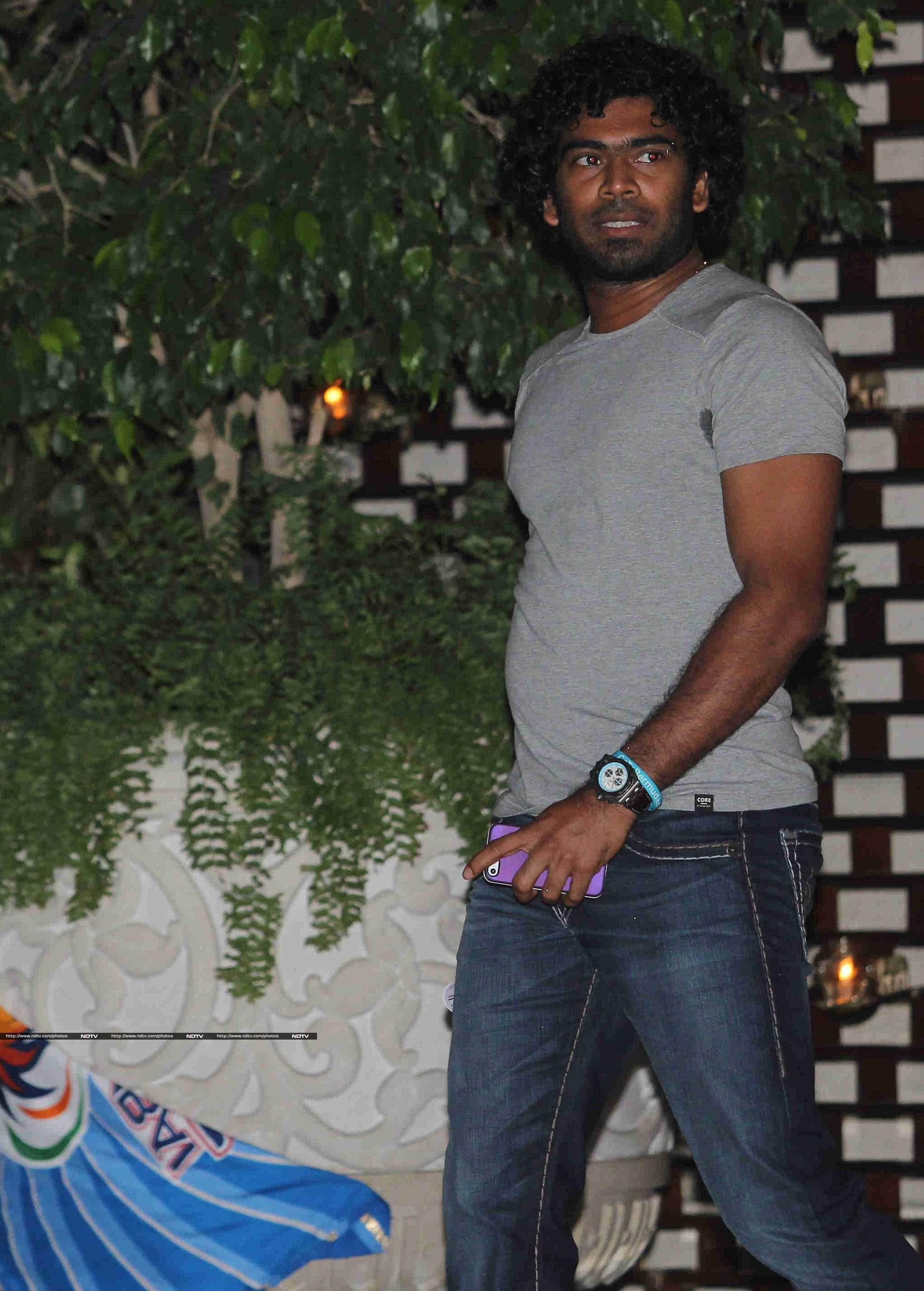 Lasith Malinga wore a grey shirt and blue denims.