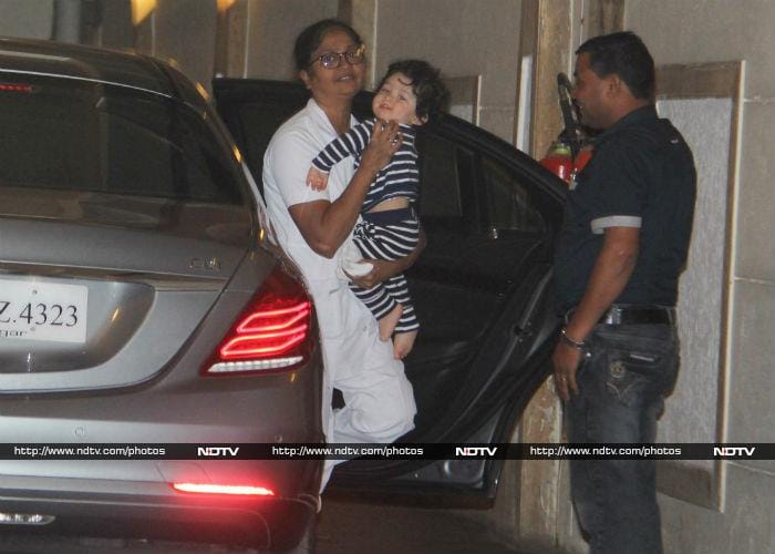 Kareena Kapoor and Saif Ali Khan's son Taimur was photographed in Bandra, reportedly at aunt Karisma Kapoor's house on Wednesday. He was cutely dressed in a white and blue stripped night suit.