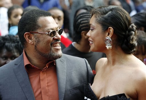 Actor Laurence Fishburne and his wife Gina Torres pictured on the red carpet at a VIP screening of the new film in which Fishburne stars, Mission: Impossible lll at the Magic Johnson Theater in New York.