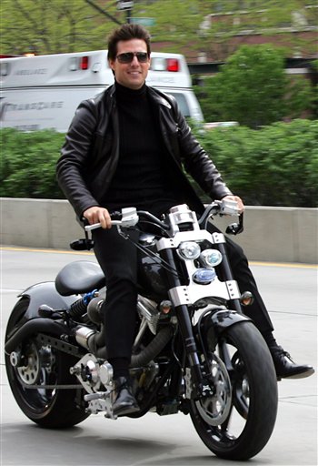 In this photo provided by Paramount Pictures,Tom Cruise races his motorcycle on the Westside Highway to promote his new film Mission Impossible III during the Tribeca Film Festival in New York.