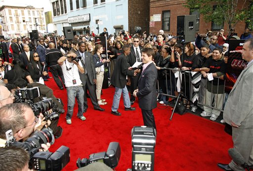 Actor Tom Cruise poses for photographers on the red carpet as he arrives for a VIP screening of his new film Mission: Impossible lll at the Magic Johnson Theater in Harlem, New York.