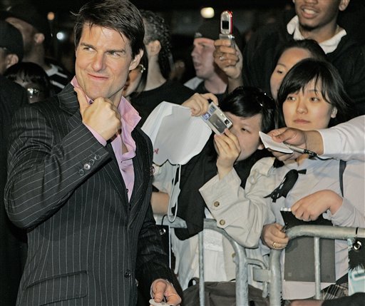 Actor Tom Cruise gives a thumbs up in front of fans as he arrives at the premiere of his new movie Mission Impossible III at the Ziegfeld Theater in New York City.