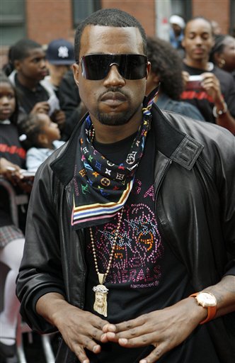 Musician Kanye West poses for photographers on the red carpet at a VIP screening of the new film, Mission: Impossible lll at the Magic Johnson Theater in Harlem, New York.