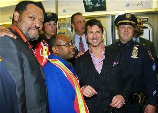 In this photo provided by Paramount Pictures,Tom Cruise, center, and Laurence Fishburne, left, get on $10,000 rented D subway train from 125th Street down to the Ziegfeld Theater for the official premiere of Mission Impossible III during the 5th Annual Tribeca Film Festival in New York.