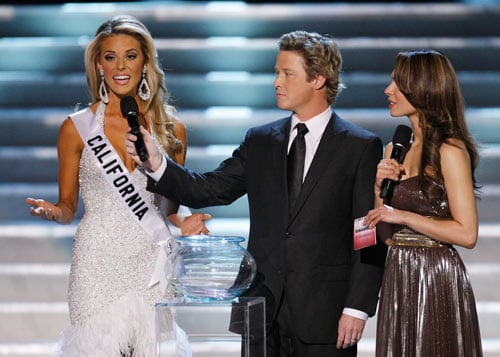 Hosts Billy Bush, center, and Nadine Velazquez, right, listen as Miss California Carrie Prejean, left, answers a question about legalizing same-sex marriage. She said, ''We live in a land where you can choose same-sex marriage or opposite marriage...I think in my country, in my family, I think that I believe that a marriage should be between a man and a woman. No offense to anybody out there, but that's how I was raised.''