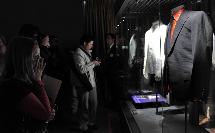 A Michael Jackson fan looks at a suit worn by the late pop singer on display at the Fashion Museum in Santiago. The Fashion Museum exhibits more than one hundred articles who belonged to the King of Pop and Chile is the first country where the collection is presented, to be continued across Asia to end in New York, where the articles will be auctioned. (Photo: AFP)