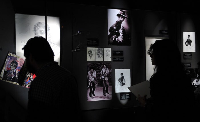 Michael Jackson fans look at pictures on display at the Fashion Museum in Santiago. (Photo: AFP)