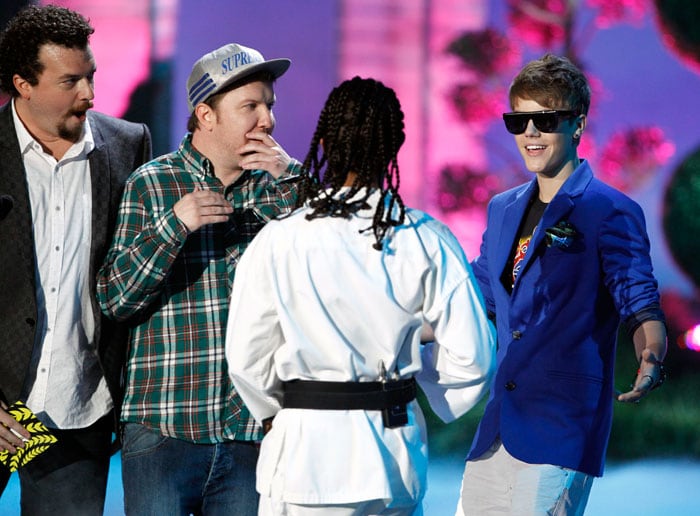 Justin Bieber accepts the award for best jaw dropping moment from Danny McBride, Nick Swardson and Aziz Ansari.