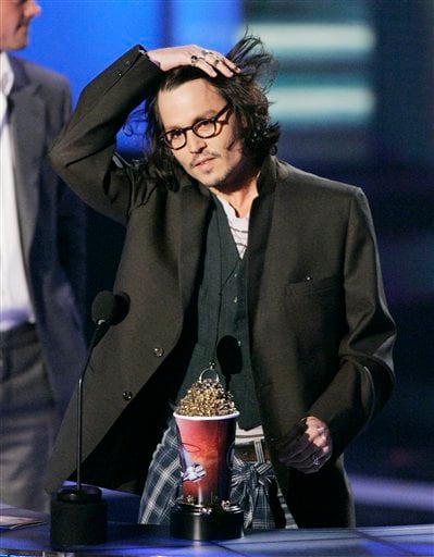 Actor Johnny Depp accepts the best performance award for Pirates of the Caribbean: Dead Man's Chest during the MTV Movie Awards in Los Angeles.