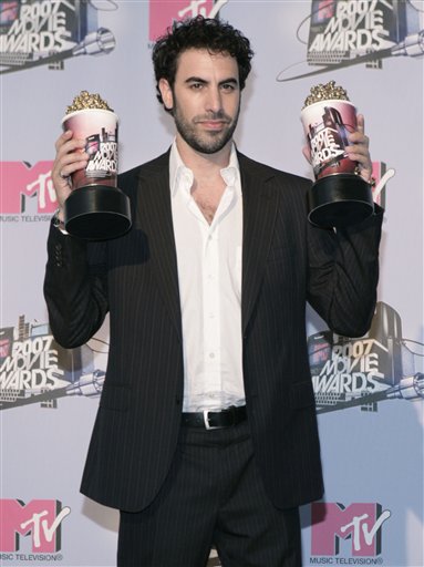 Sacha Baron Cohen poses with his awards for Best Kiss and Best Comedic Performance in the press room during the MTV Movie Awards in Los Angeles.