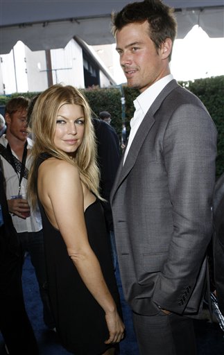 Fergie and Josh Duhamel poses together backstage during the MTV Movie Awards in Los Angeles