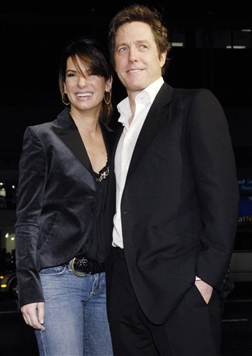 Hugh Grant, right, a cast member in the film Music and Lyrics, poses with Sandra Bullock at the premiere of the film in Los Angeles.