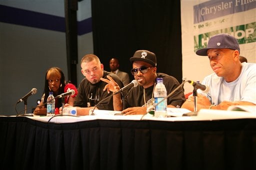 In this photo provided by the Hip-Hop Summit, Jermaine Dupri, second from right, speaks to attendees at Morris Brown College in Atlanta about financial empowerment as Remy Ma, left, Paul Wall, and Russell Simmons, right, listen. The entertainers along with financial advisers, said financial planning and credit stability should be a priority for youngsters, rather than spending their money on material items.