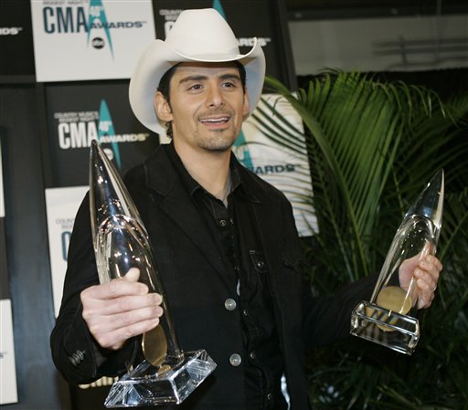 Brad Paisley holds his Album of the Year and Musical Event of the Year awards backstage at the 40th Annual CMA Awards in Nashville.