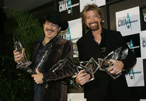 Kix Brooks, left, and Ronnie Dunn hold their awards backstage at the 40th Annual CMA Awards in Nashville.