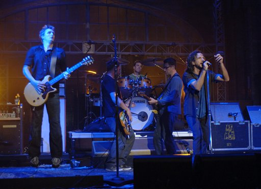 In this photo released by CBS, Eddie Vedder, right, leads Pearl Jam; Mike Cameron on drums, Jef Ament, center, on bass, Mike McCready, left, and Stone Gossard, right, on guitars, as they perform on stage at the Ed Sullivan Theater during an exclusive, live concert webcast on the Late Show with David Letterman in New York.