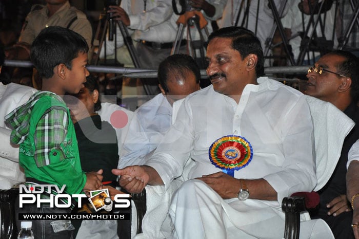 N Kiran Kumar Reddy obliges a young boy at the ceremony.