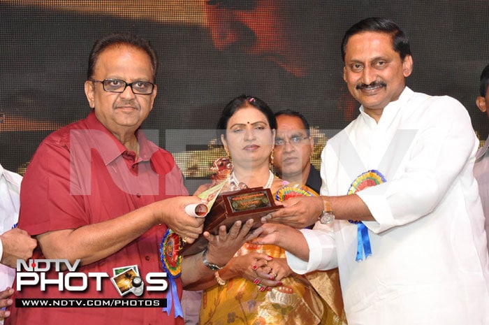 Singer and actor SP Balasubramanium collects his award from N Kiran Kumar Reddy.